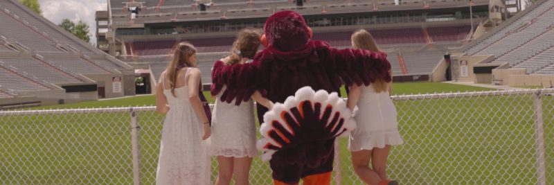 The HokieBird poses with several Relay for Life participants